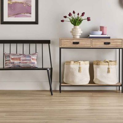 curated spaces by Skelton's design in a hallway with laminate floors, storage, and a bench